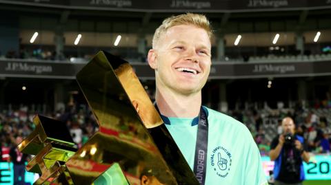 Oval Invincibles captain Sam Billings smiles as he holds up The Hundred 2024 trophy