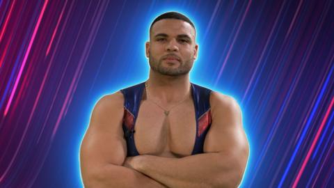 Steel stands with his arms folded in his Gladiator costume