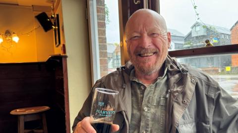 Mike Deacon drinking a pint of beer in the pub