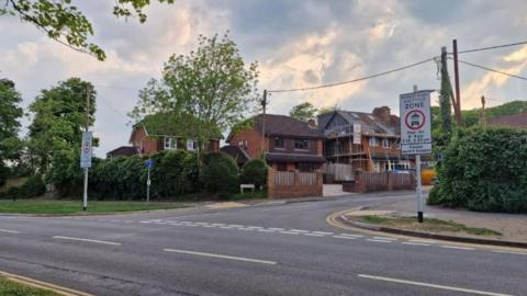An image of Bullers Road which will be part of Surrey's first Safer Street scheme. The two pedestrian signs can be seen either side of the road's entrance.