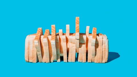 A loaf of sliced white bread on a blue background 