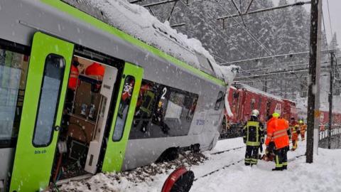 A Swiss BLS train is covered in snow following a derailment on the line linking Goppenstein to Hohtenn which injured at least five people, according to police.