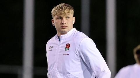 Danny Eite standing on a pitch wearing England kit in 2023