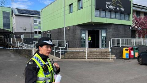 Police officer outside of the school 