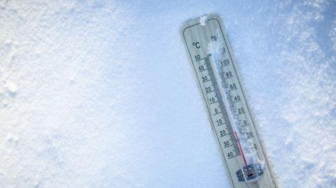 A thermometer in the snow. 