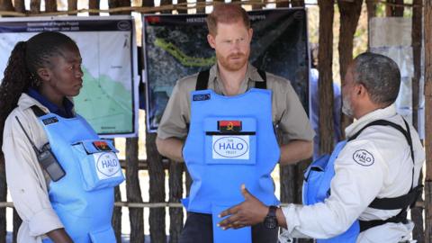 Prince Harry in Angola wearing body armour to clear a minefield