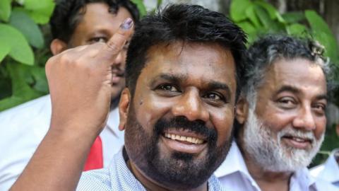 Anura Kumara Dissanayake, presidential candidate and leader of the opposition party National People's Power (NPP), shows his ink-marked finger after casting his vote during the presidential election, in Colombo, Sri Lanka, 21 September 2024.