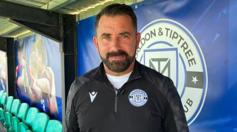 Kevin Horlock pictured in front of a Maldon & Tiptree sign