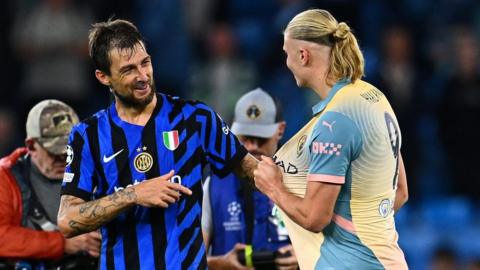 Francesco Acerbi and Erling Haaland discuss swapping shirts at the end of the Champions League match between Inter Milan and Manchester City