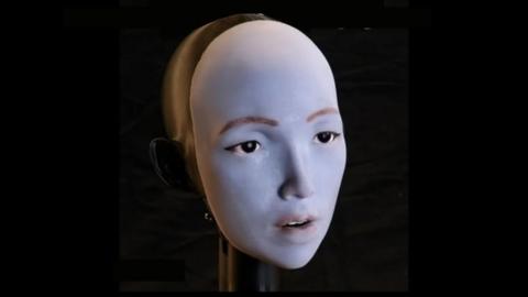 close up photo of the face of EMO the robot