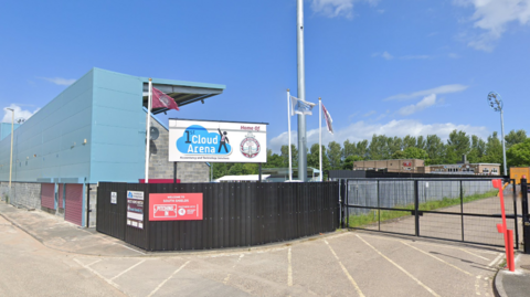 The Cloud Arena, home to South Shields FC, which has black fencing and turquoise stands.