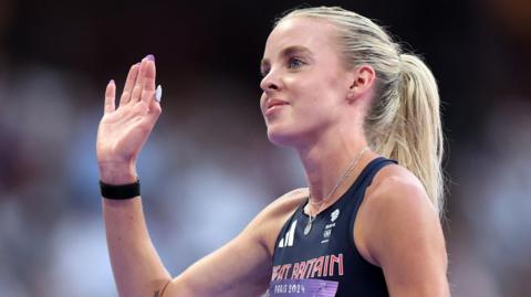 Keely Hodgkinson waves to the crowd at Stade de France