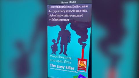 A digital poster showing a graphic of a wood-burning stove that was emitting smoke in the shape of an adult and child