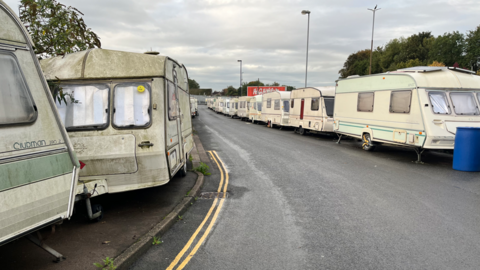 The caravans in Bristol lined up on either side of the road where ˿ Office officials raided last week