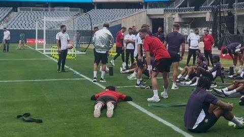 Manchester United staff wearing the new grey cooling jackets