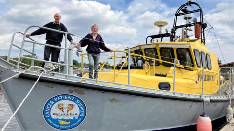 David Cowper and Susannah Broome standing on the bow of Polar Bound