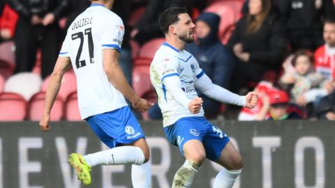 Conor Chaplin celebrates his stoppage-time winner for Portsmouth.
