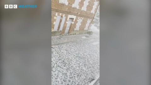 image of a street covered in white hailstones