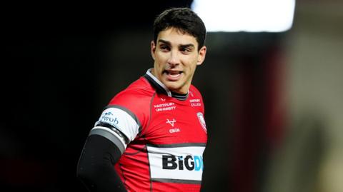 Santiago Carreras standing on the pitch during a Gloucester match