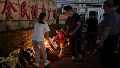 Members of the public leaving flowers and other tributes outside the stadium on Tuesday