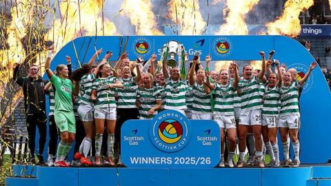 Kelly Clark lifting the Women's Scottish Cup trophy.