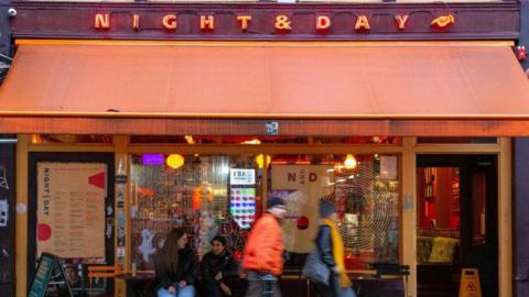 People walking past the Night and Day music venue in Manchester