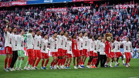 Bayern Munich players line up to celebrate winning the Bundesliga title
