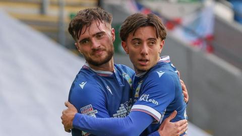 Linfield goalscorer Euan East is congratulated by Sam Taylor