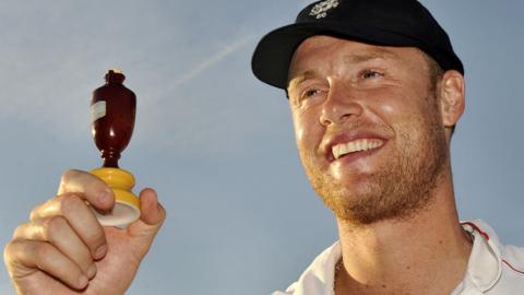 Flintoff with the Ashes trophy smiling