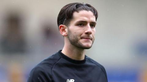York City's Ricky Aguiar looks pensive in a warm-up top
