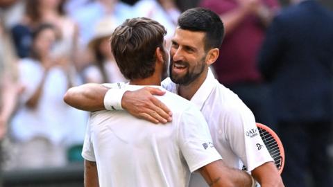 Djokovic hugs Cobolli at the net