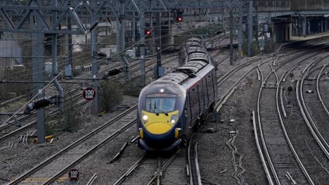 A blue Southeastern High Speed train leaves Ashford station in Kent