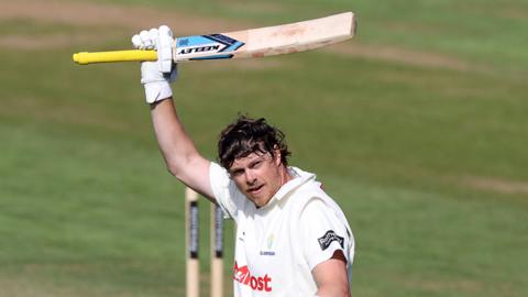Sam Northeast raises bat in celebration