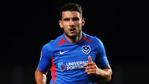 former portsmouth player gareth evans looks forward with a concentrated look on his face swinging his arms as he runs