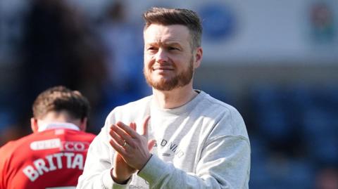 Middlesbrough boss Kim Hellberg, wearing a light grey jumper, claps the fans after the 0-0 draw against Blackburn at Ewood Park on 21 March