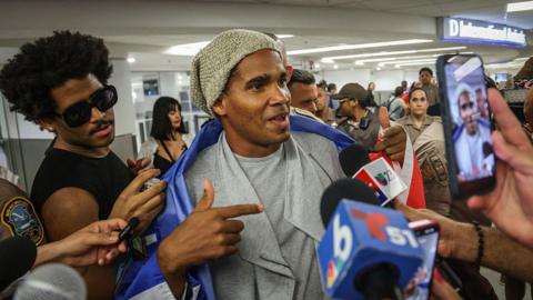 Luis Manuel Otero Alcántara speaks to journalists at Miami airport.