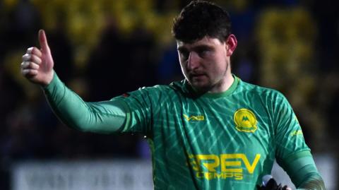 Torquay goalkeeper James Hamon gives a thumbs up