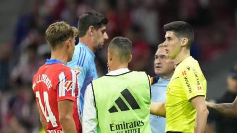 Real Madrid goalkeeper Thibaut Courtois speaks to match officials during the La Liga match between Atletico Madrid and Real Madrid