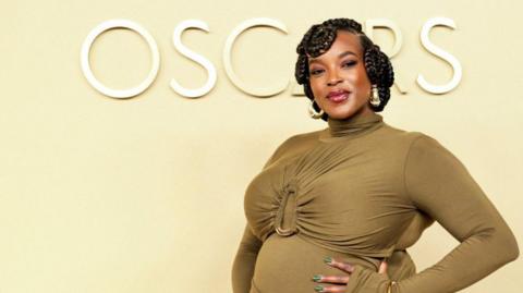 Wunmi Mosaku, who is pregnant and is wearing a khaki-coloured dress, arrives for the 98th Oscars Nominees Luncheon at the Beverly Hilton Hotel in Beverly Hills.