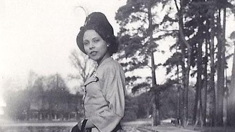 A black and white picture of Andrée Blouin wearing a hat