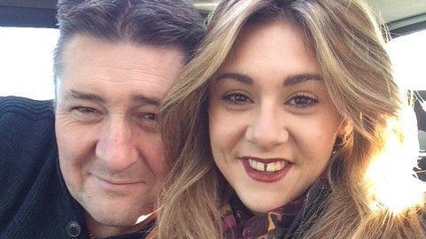 Karl Edgeller is on the left, smiling into the camera. He has short dark hair and is wearing a navy knitted top. Karlynn West is on the right. She is looking into the camera, grinning, and is wearing red lipstick. Her hair is blonde and wavy.