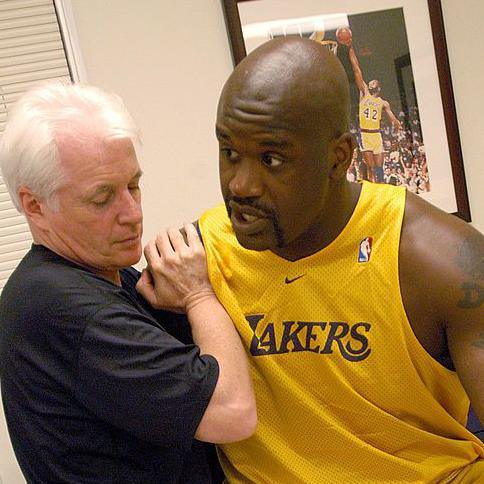 Alex McKechnie doing some physio with Shaquille O'Neal