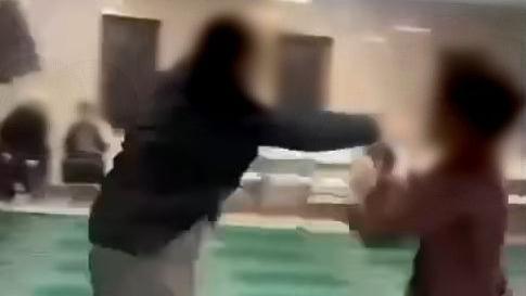 An image taken from a video of a man slapping a child across the face at a mosque in West Yorkshire 