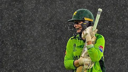 Pakistan batter Natalia Pervaiz holds her bat in the rain