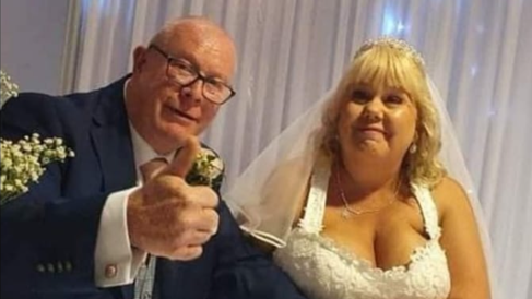 Ms Jobling, in a while wedding gown, with husband Sid, wearing a navy suit, on their wedding day