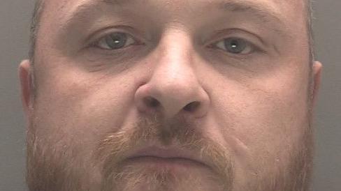 A police mugshot of Terence Rice, 36, who is heavy-set and has ginger hair and a ginger beard.