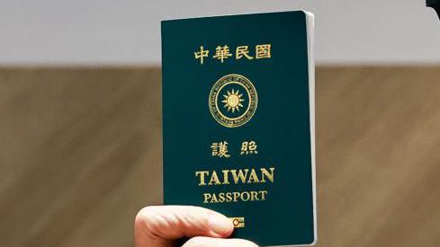 A close-up photo of a Taiwanese passport, being held by a person 