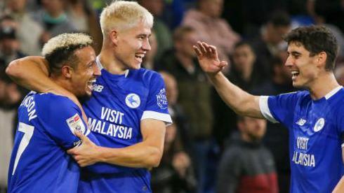 Cardiff City players Callum Robinson (L), Rubin Colwill (C) and Callum O'Dowda (R) celebrate