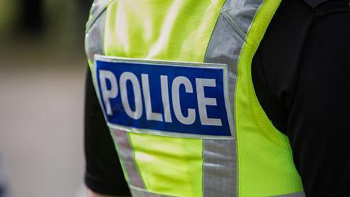 Getty stock image of a police's jacket with POLICE on the back