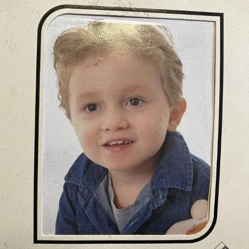 A picture in a white frame of a much younger Keaton, wearing a denim jacket and smiling